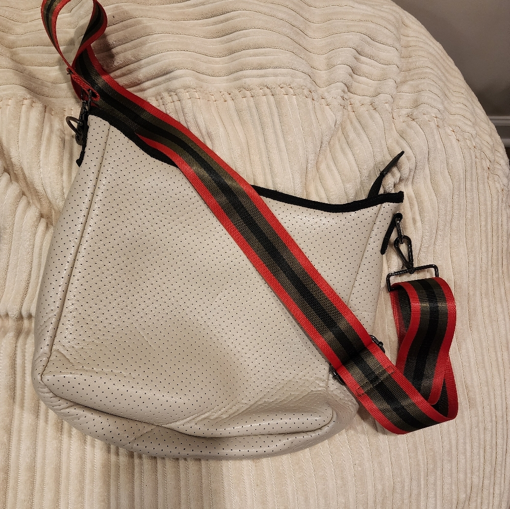 Haute Shore Neoprene cross body bag light beige with black and red accents. - Picture 1 of 3